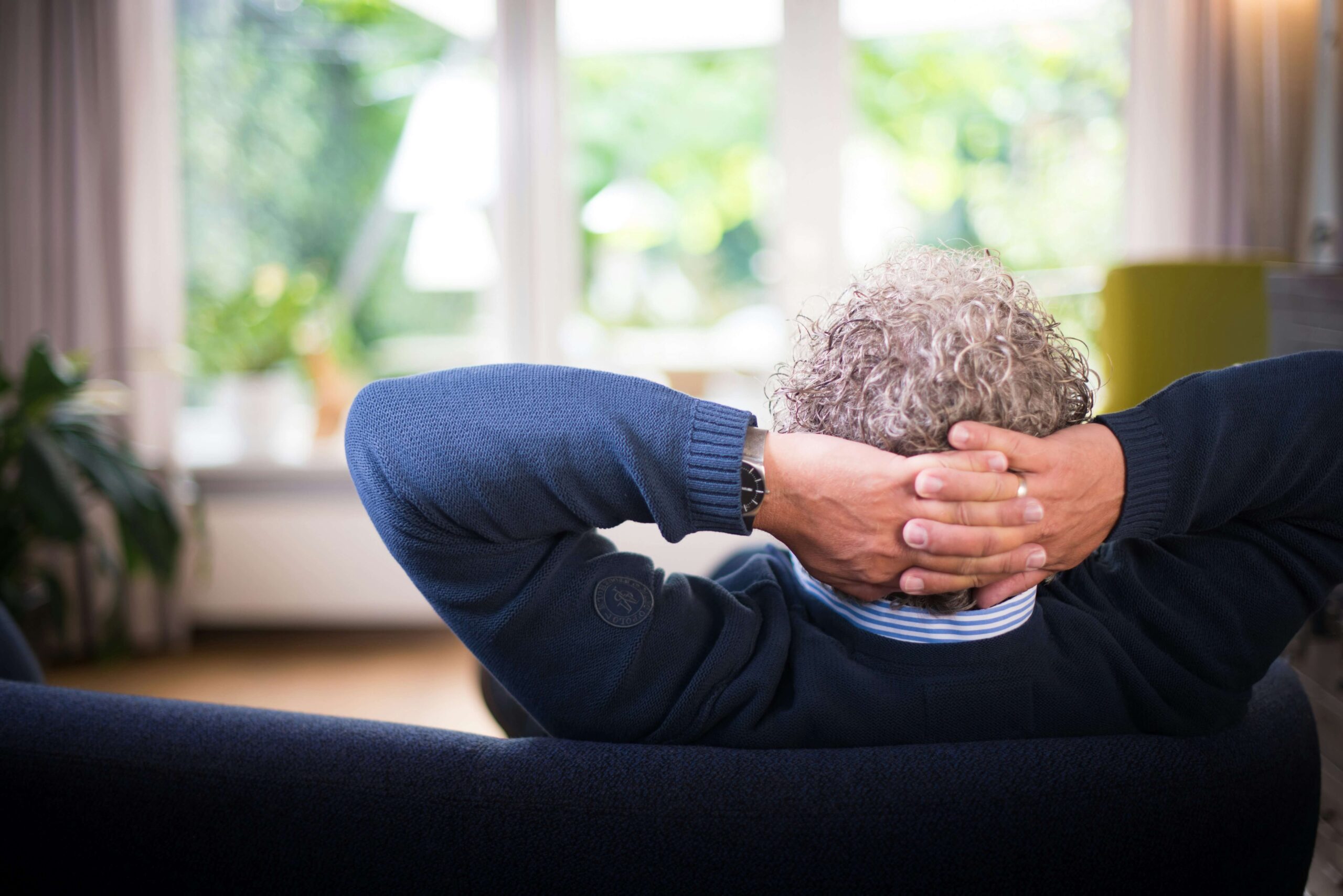 Image of man on couch to illustrate time spent watching an ad